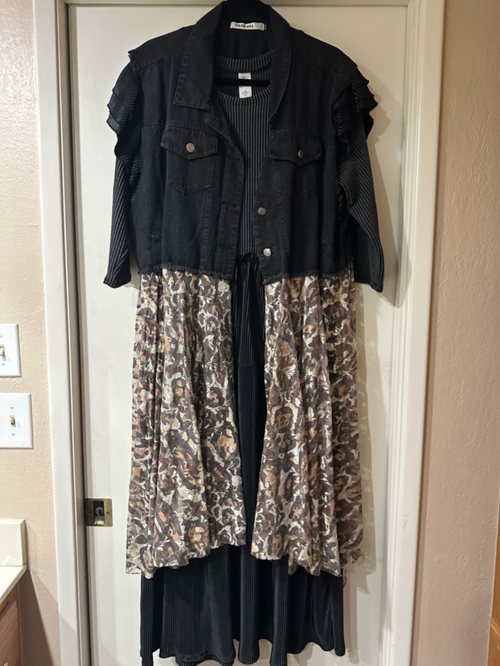 Black dress with ruffled sleeve detail and black denim vest with leopard lace